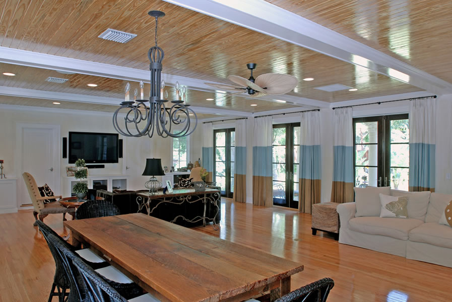Great room with pine ceiling, custom ironwork chandelier and reclaimed wood table