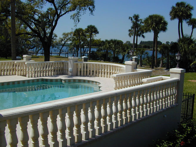 Balustraded pool terrace overlooking the water